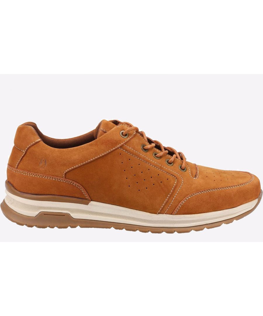 Tan suede men's shoe with a textured upper, perforated detailing, lace-up design, and a cushioned sole for comfort, featuring a sporty yet casual style.