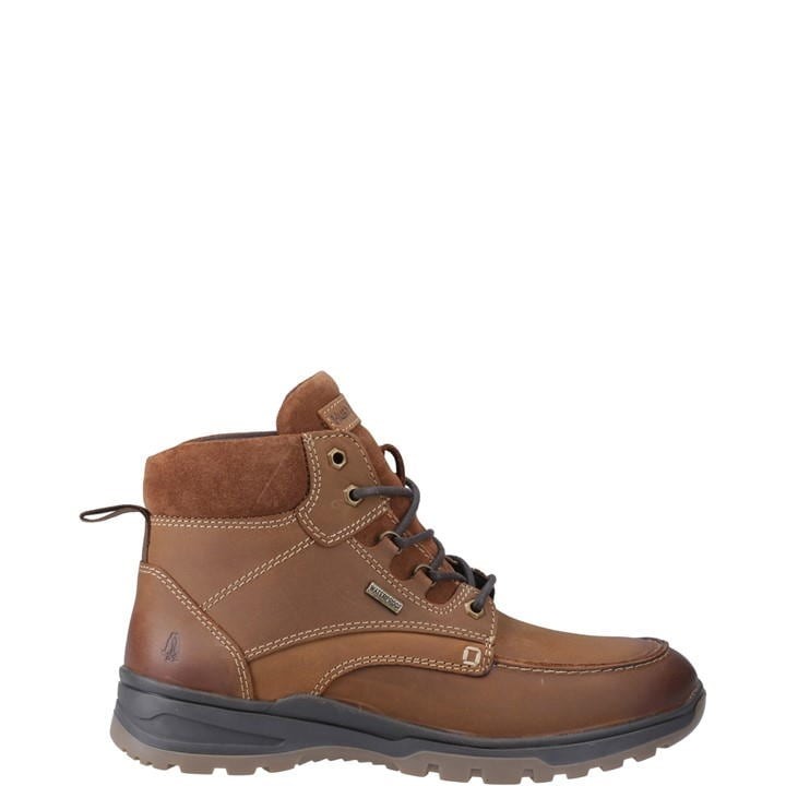 Tan leather and suede men's boot with a padded collar, lace-up front, and rugged rubber sole, featuring Hush Puppies logo on the side. Size 6.