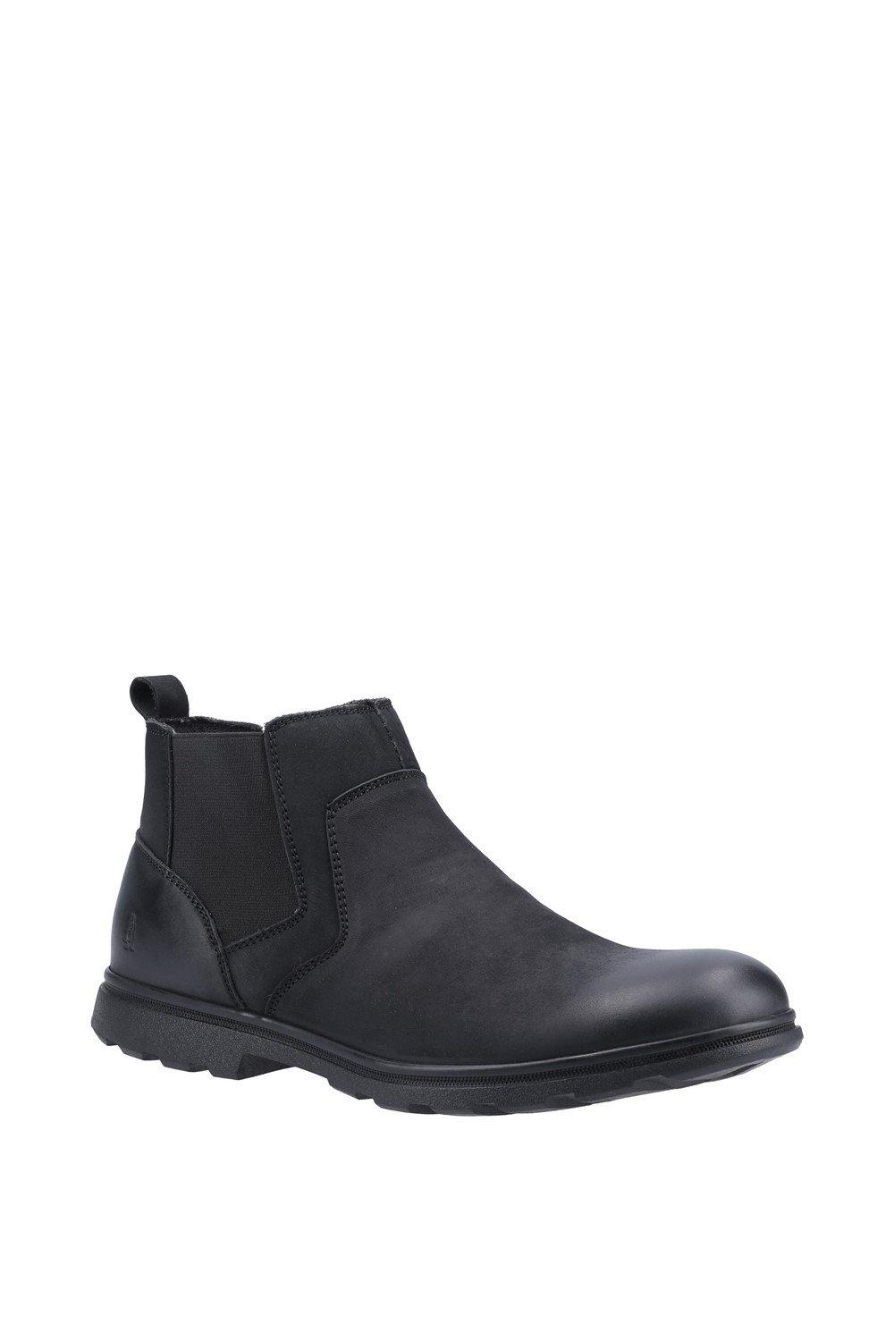 Black leather ankle boots with elastic side panels, a pull tab at the back, and a textured rubber sole, labeled as "Hush Puppies Men 'Tyrone'," size 6.