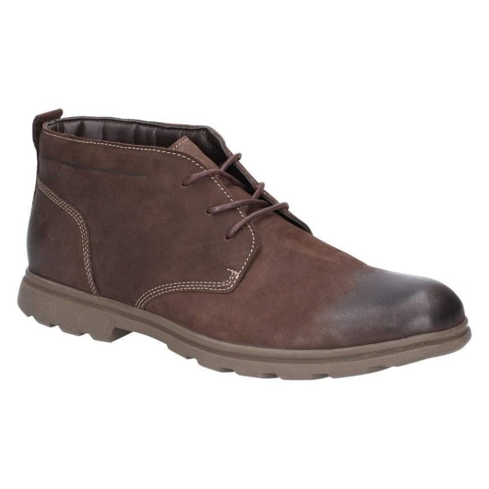 Brown leather chukka boot featuring a rounded toe, lace-up design, and a textured rubber sole, available in size 12 by Hush Puppies.
