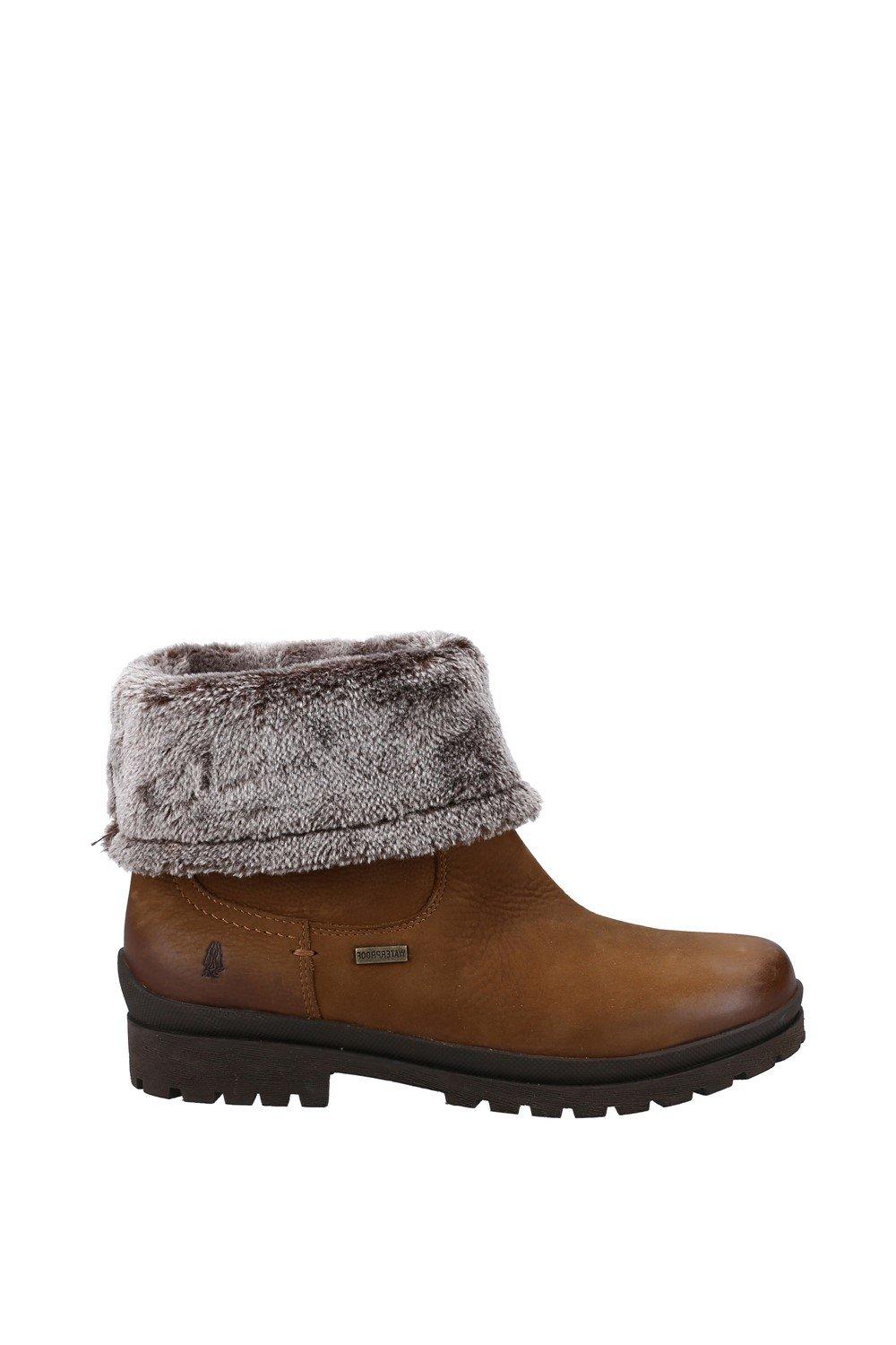Camel-colored leather ankle boots featuring a soft, faux fur cuff, rugged sole, and Hush Puppies logo on the side.