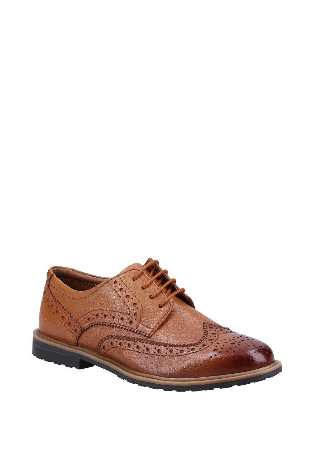 Brown leather brogue shoe featuring intricate perforated detailing, a classic lace-up design, and a sturdy black rubber sole.
