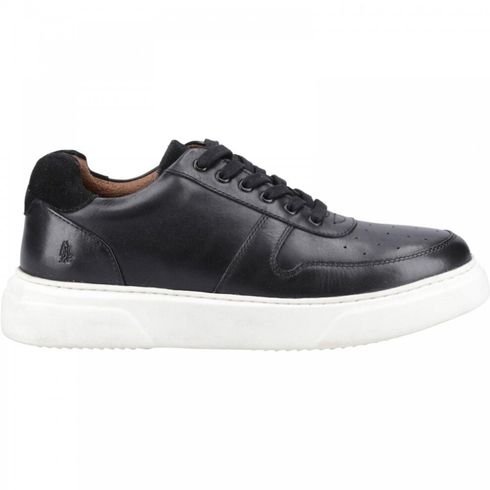 Black leather Hush Puppies 'Wyatt' sports shoes featuring perforated detailing, a cushioned white sole, and black laces, available in size 6.