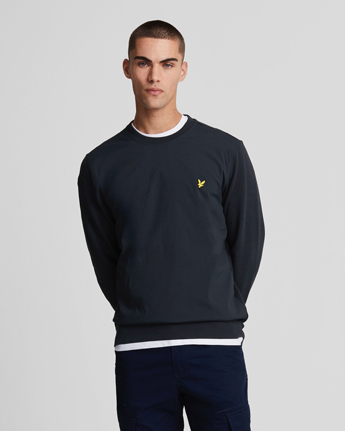 Navy hybrid sweatshirt for men by Lyle & Scott, featuring a round neckline, long sleeves, and a small yellow logo on the chest, made from a comfortable material.