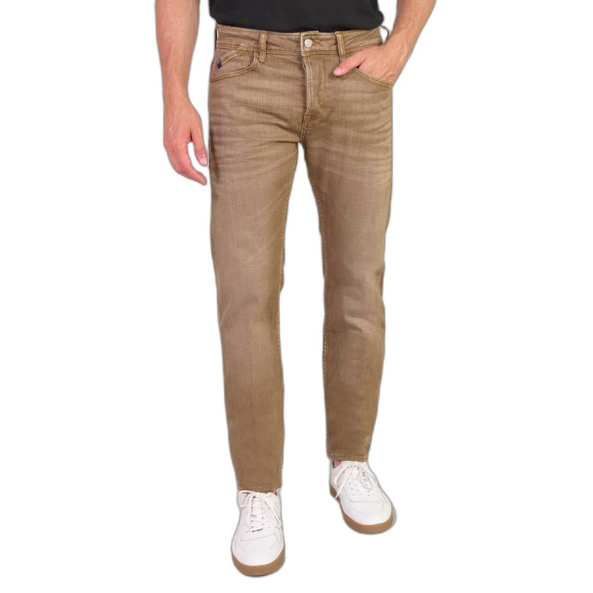 Light camel-colored denim jeans with a faded finish, featuring a slim fit, five pockets, and a classic button and zip fly closure, paired with white sneakers.
