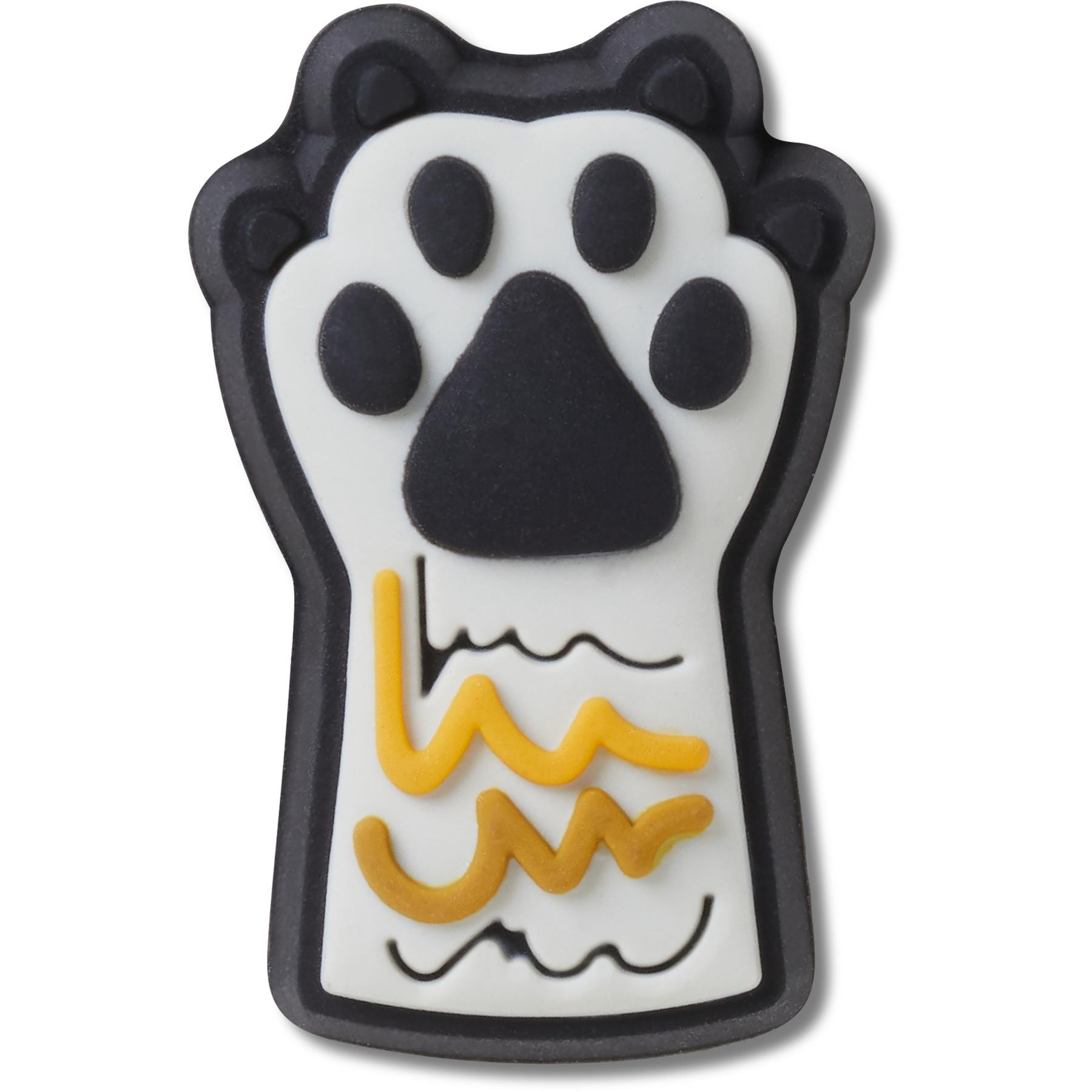 A black and white rubber Jibbitz charm shaped like a kitty paw, featuring a black paw print and yellow wavy lines on a white background.
