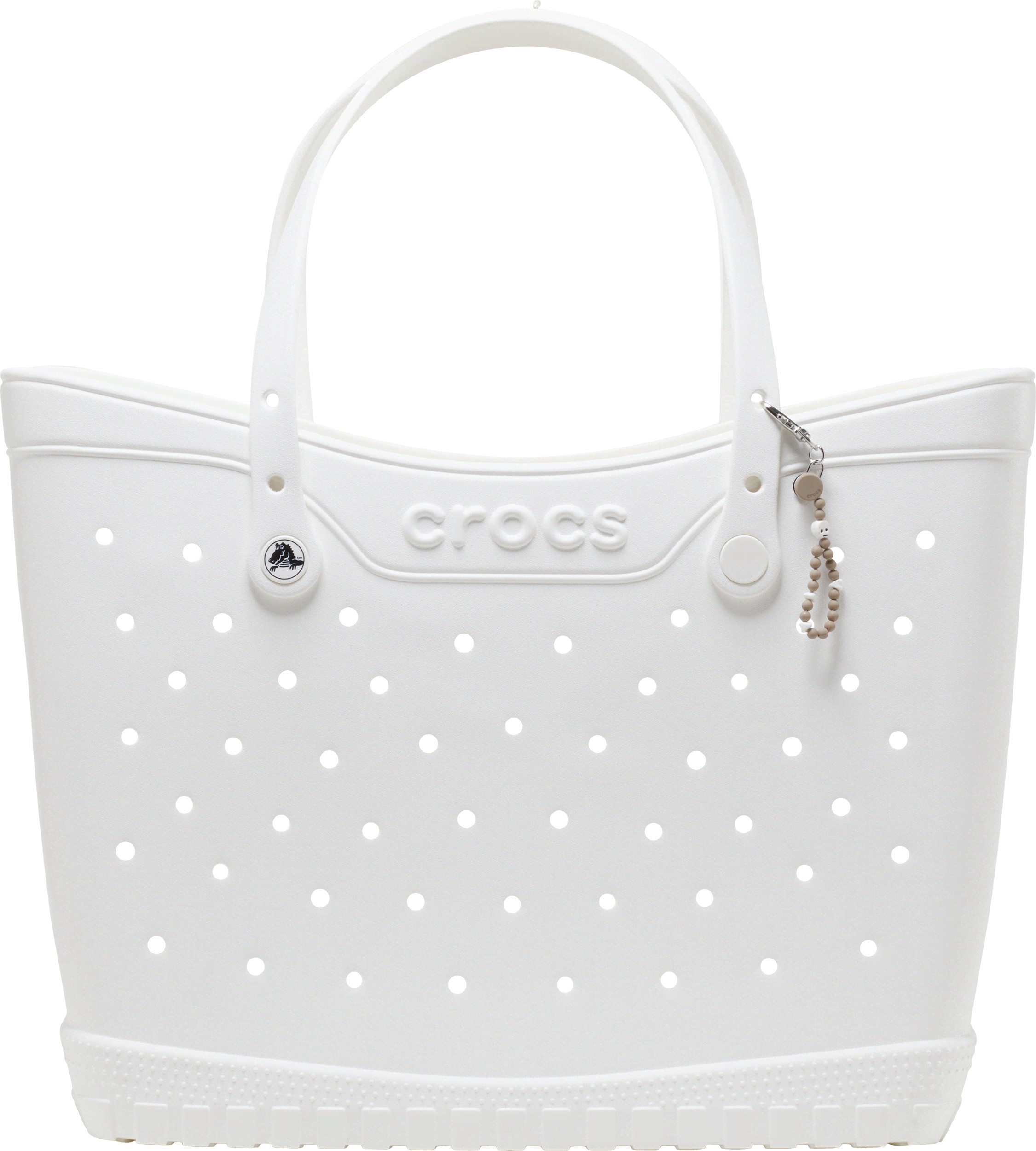White Crocs tote bag with perforated design, featuring a rounded top, two handles, and a small key chain with a skull charm attached.