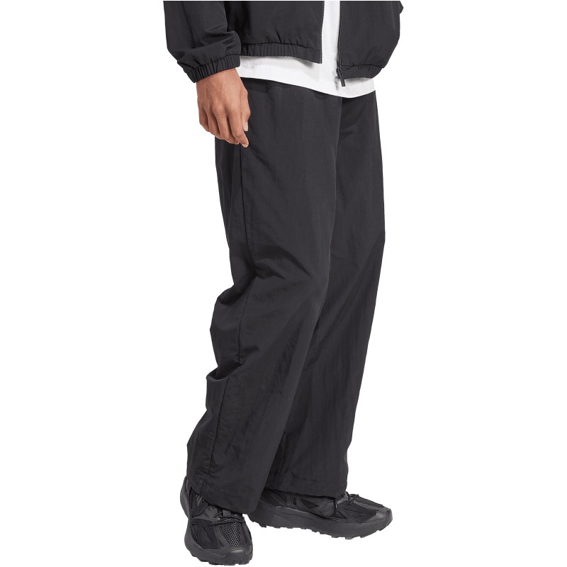 Black jogging trousers with a small Adidas logo, featuring a relaxed fit, lightweight material, and elastic waistband, ideal for casual or athletic wear.