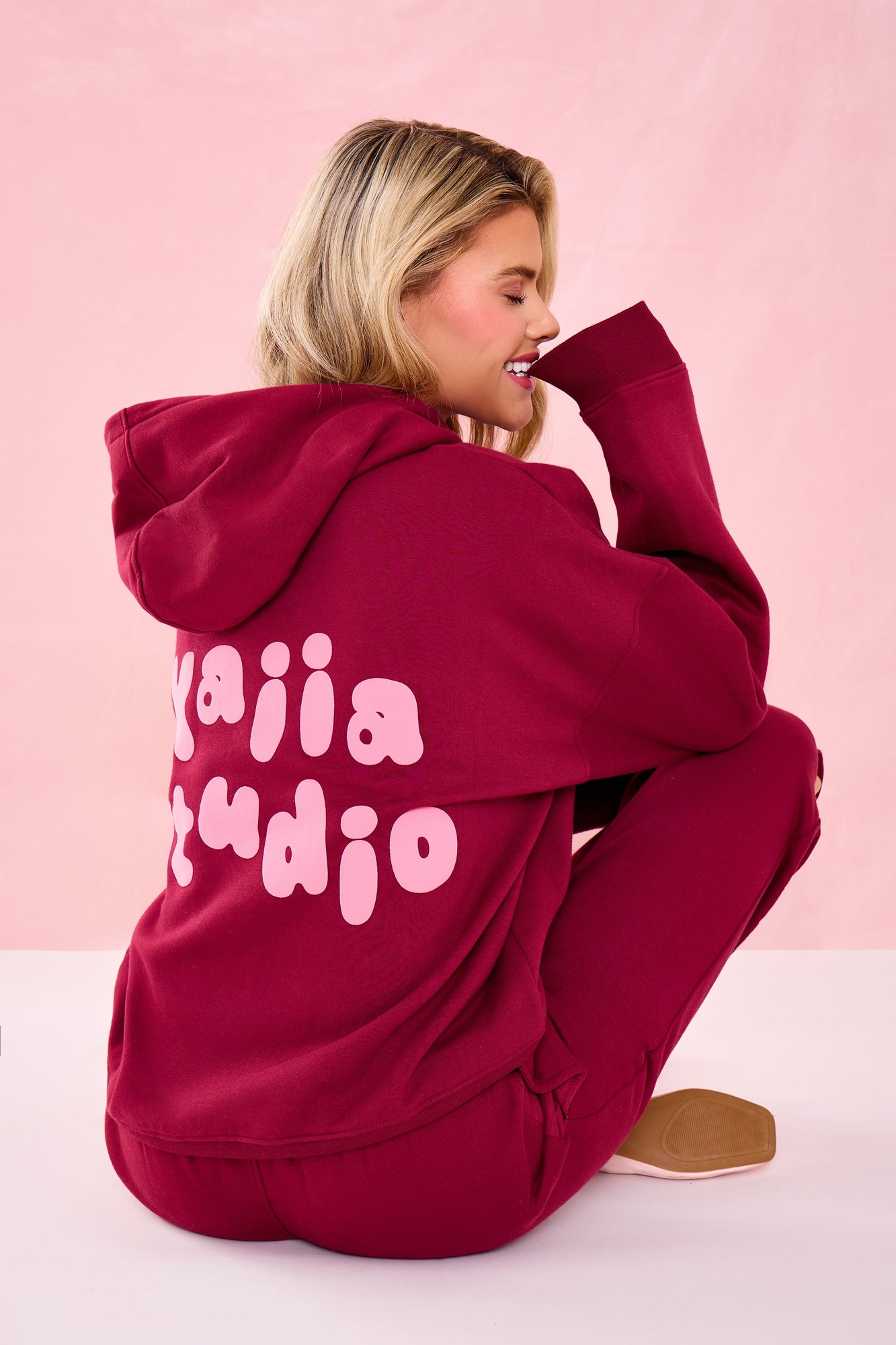 Raspberry jelly oversized hoodie featuring a playful bubble graphic in pink on the back, with a relaxed fit and soft material, styled with matching bottoms.