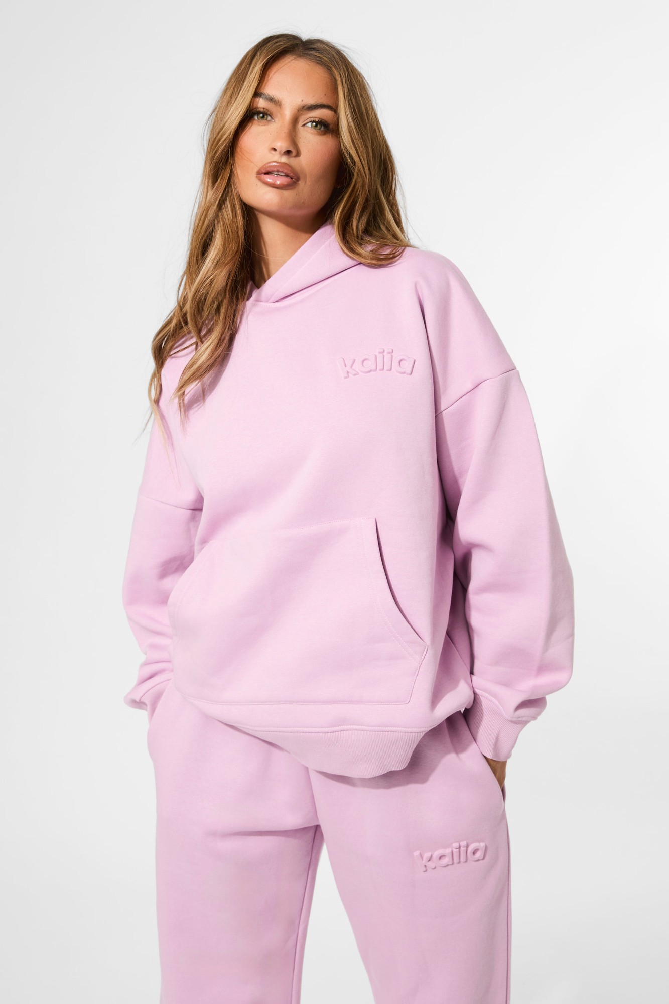 Oversized hoodie in parma violet featuring an embossed "Kaiia" logo, made from soft material with a front pocket and a relaxed fit.