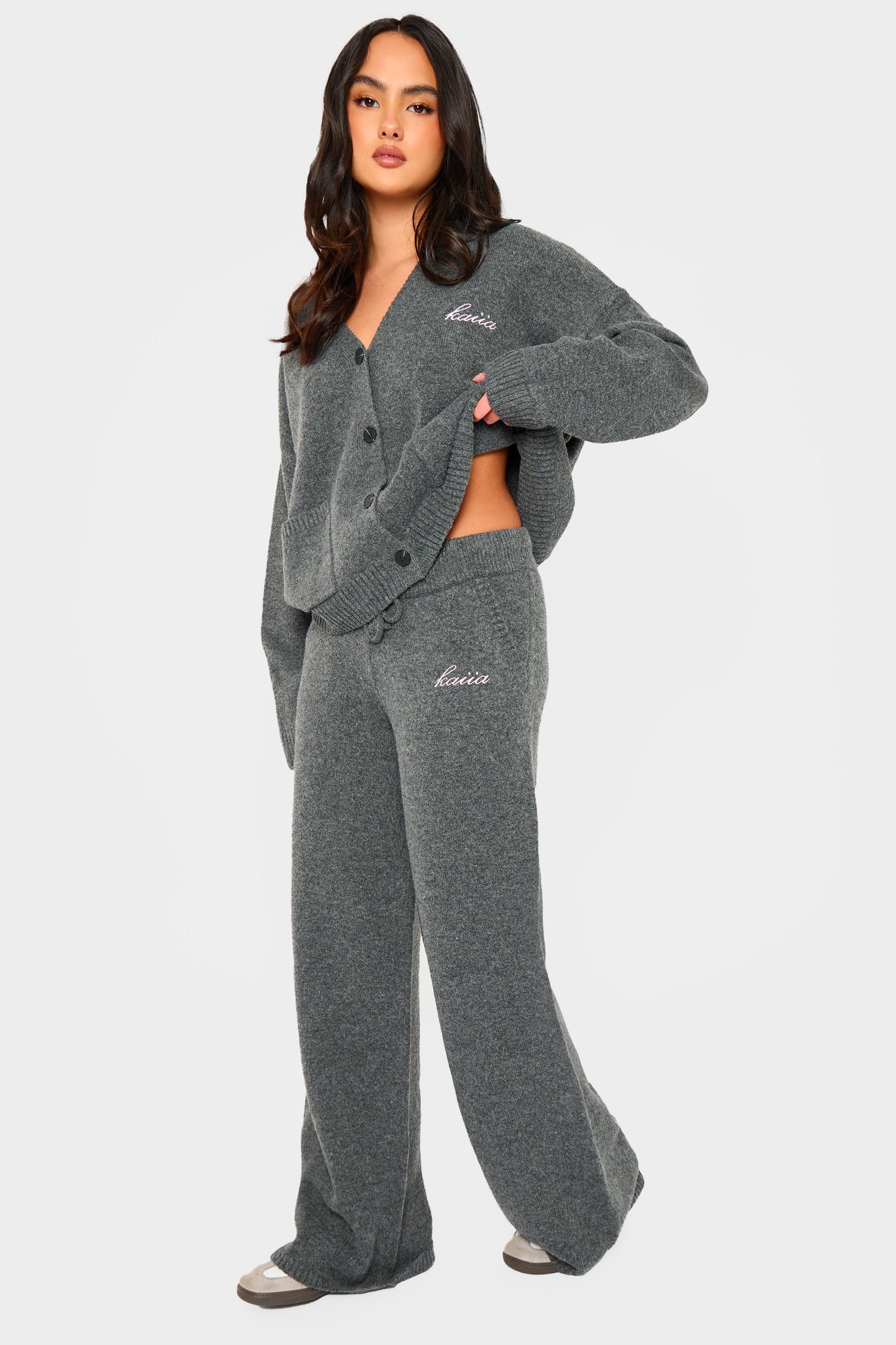 Charcoal knit wide-leg trousers by Kaiia, featuring a soft texture, elastic waistband, and a relaxed fit, styled with a matching cardigan for a cozy look.