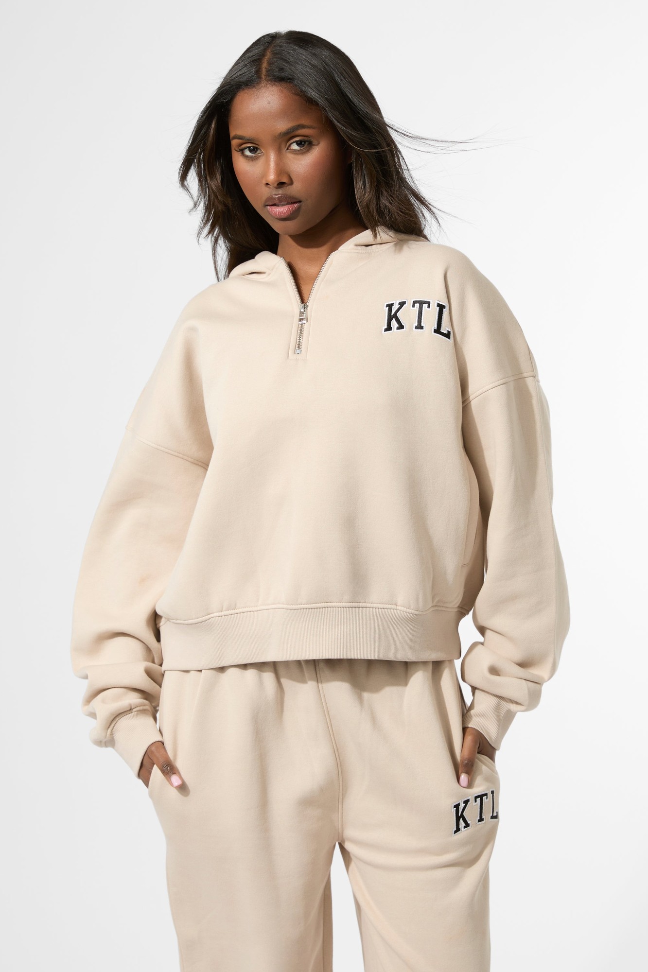 Oversized zip-up hoodie in a soft truffle color, featuring a front zipper, a hood, and "KTL" logo embroidered on the left chest.