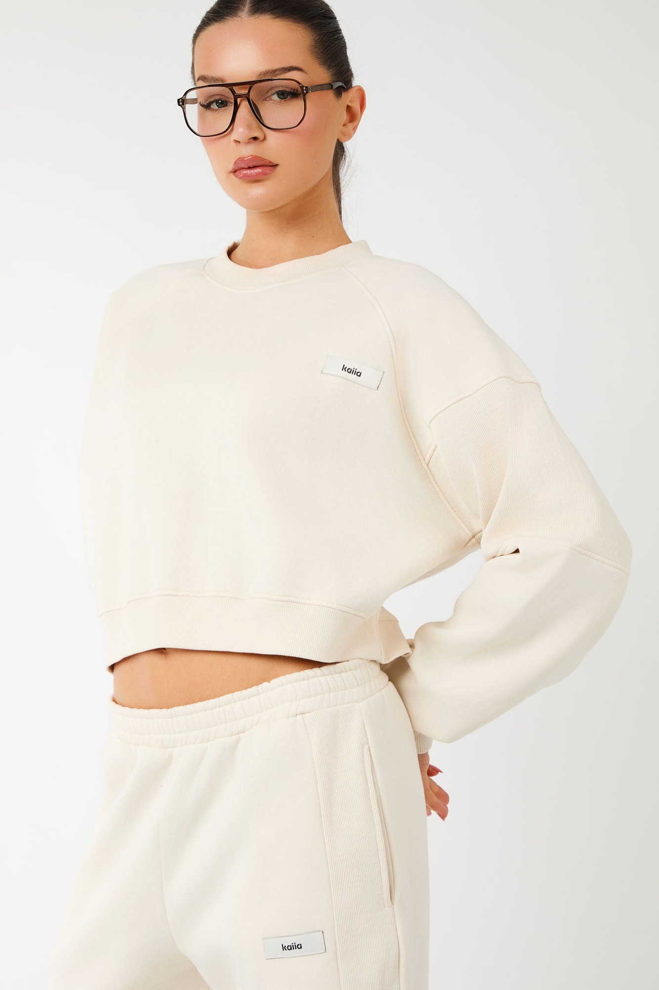 Cream rib panel cropped oversized sweatshirt with a relaxed fit, featuring a small Kaiia label logo on the chest and matching sweatpants.