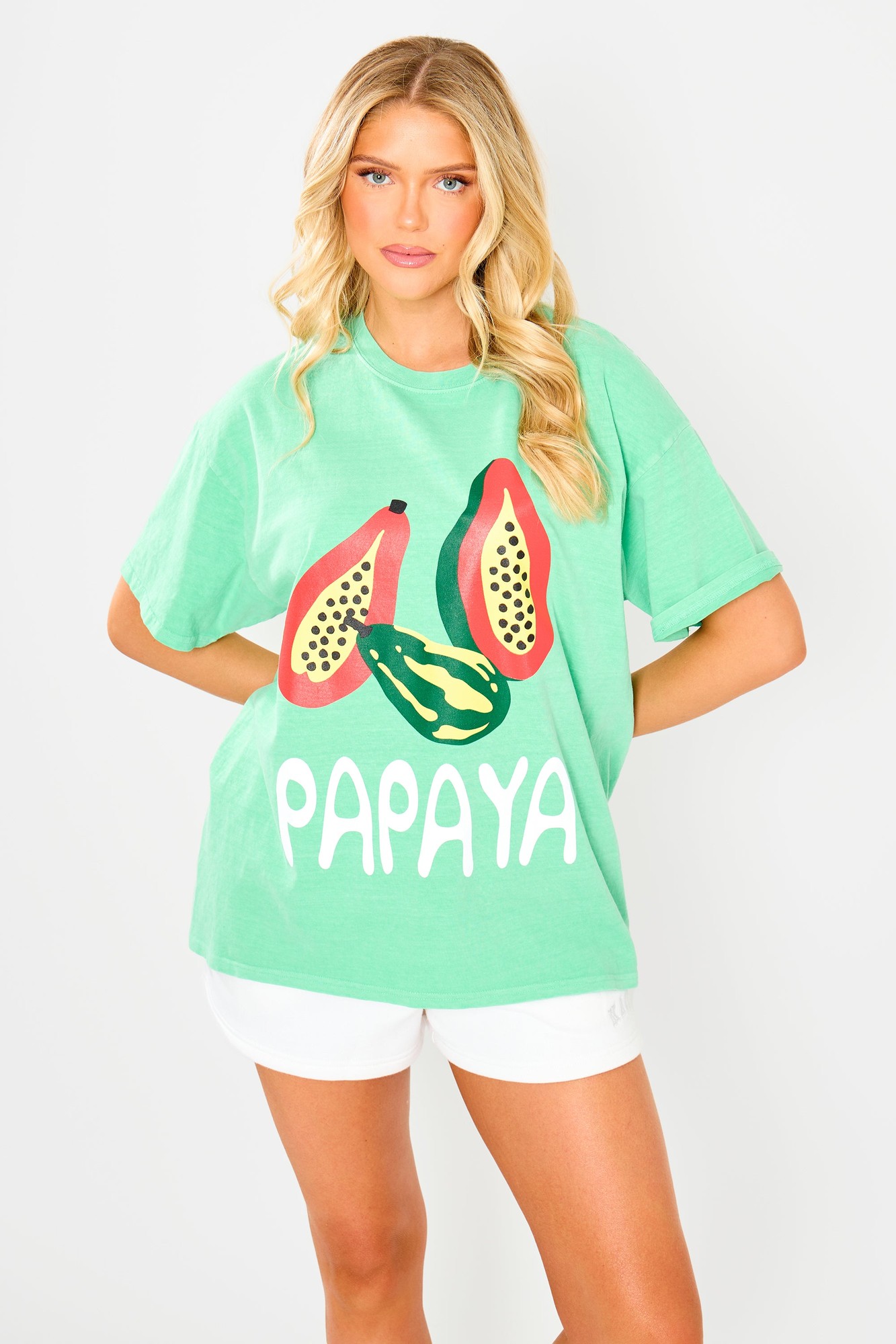 Green oversized t-shirt featuring a bold graphic of papayas and the word "PAPAYA" in white, made from soft material, perfect for casual wear.