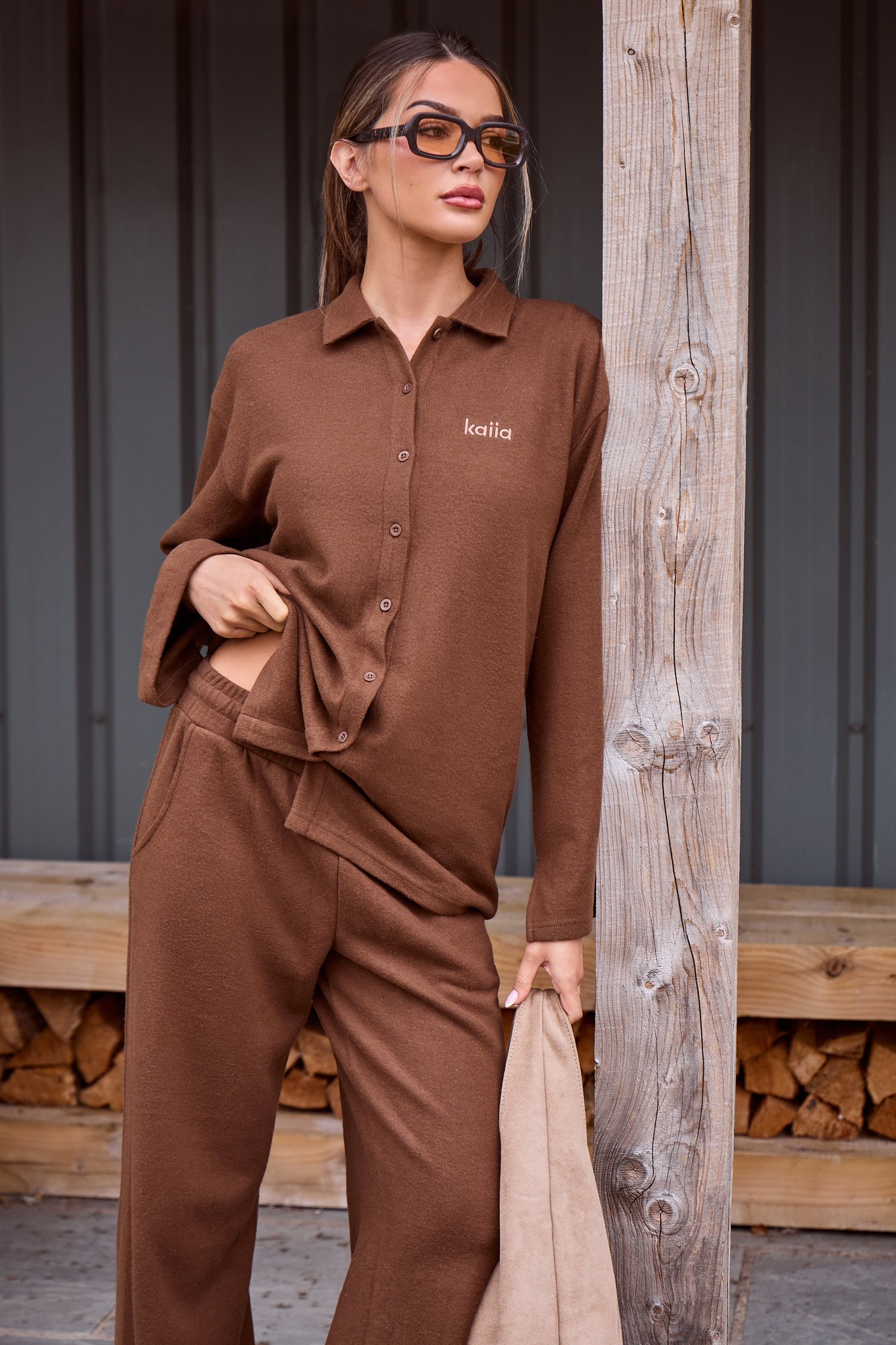 Supersoft coffee-colored button-down shirt by Kaiia, featuring a classic collar, long sleeves, and a subtle logo on the chest, paired with matching pants for a coordinated look.