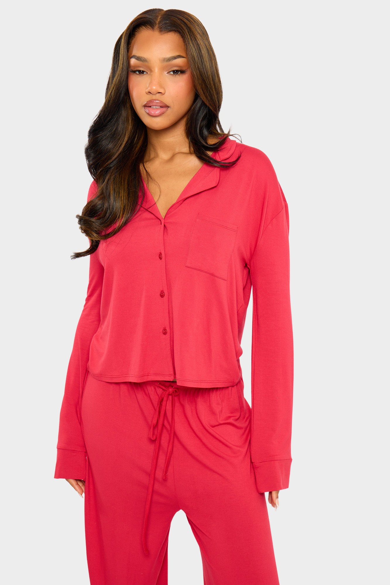 Red supersoft slouchy button-up pyjama shirt with a relaxed fit, featuring a single chest pocket and long sleeves, paired with matching pants.