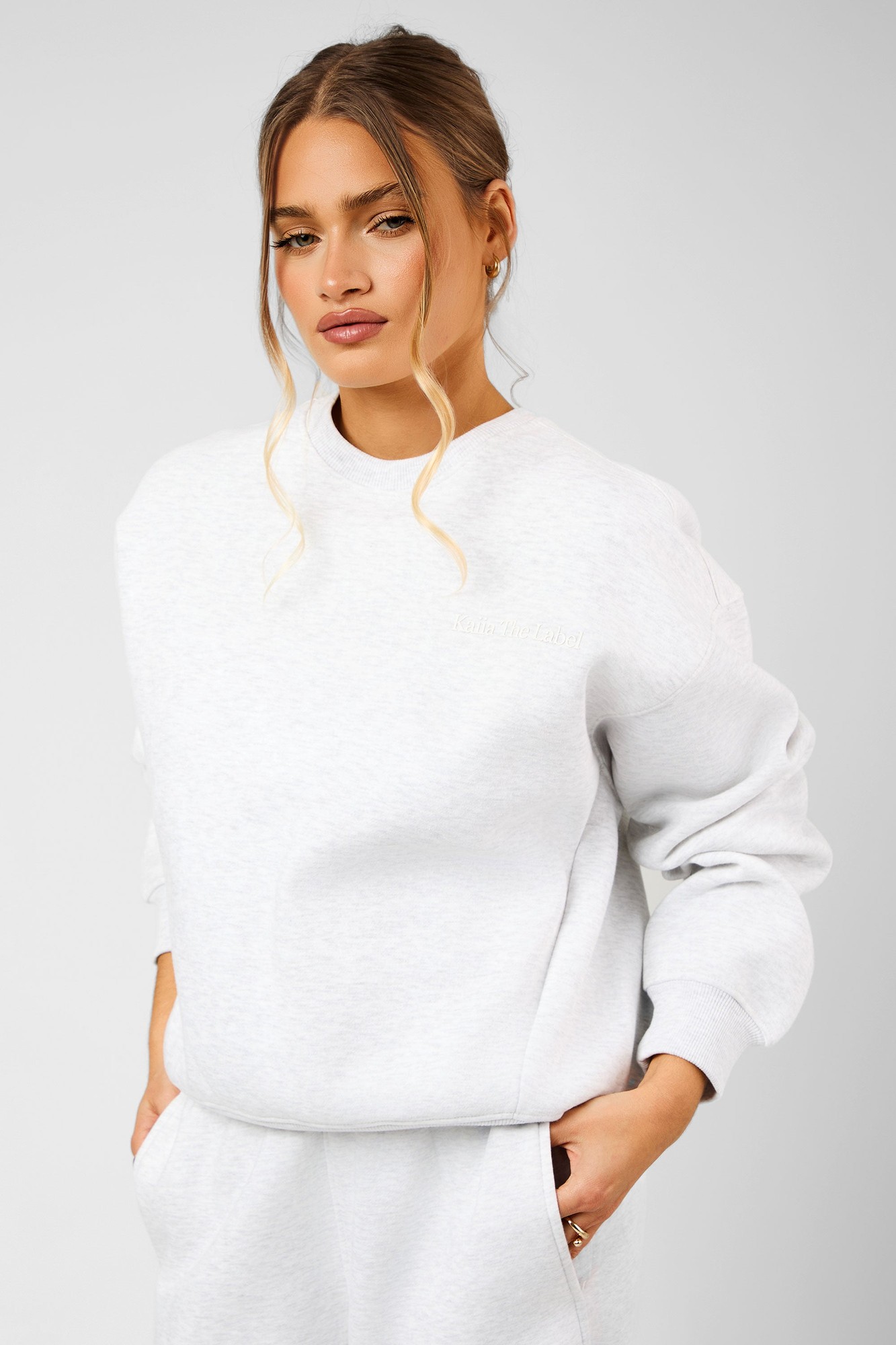 Light grey marl oversized sweatshirt with seam detail, featuring a relaxed fit, ribbed cuffs, and a subtle logo on the chest, made from soft, comfortable material.