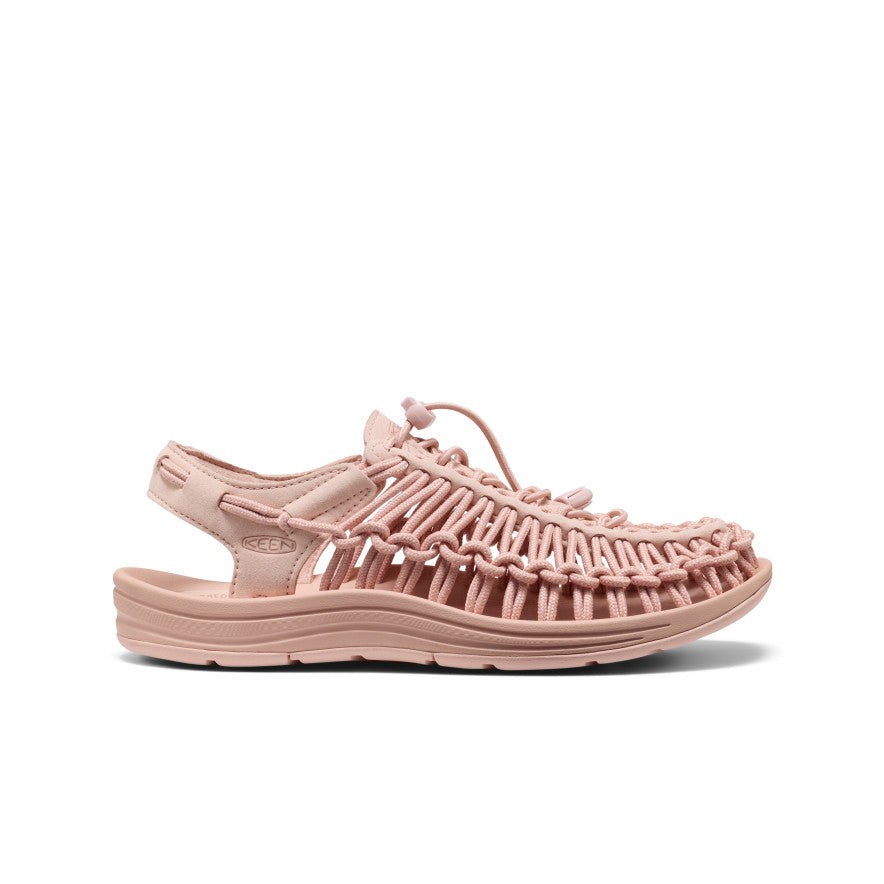 Women's UNEEK sneaker in Cameo Rose features a woven upper, adjustable bungee cord, and a cushioned sole for comfort, designed for a casual, breathable fit.