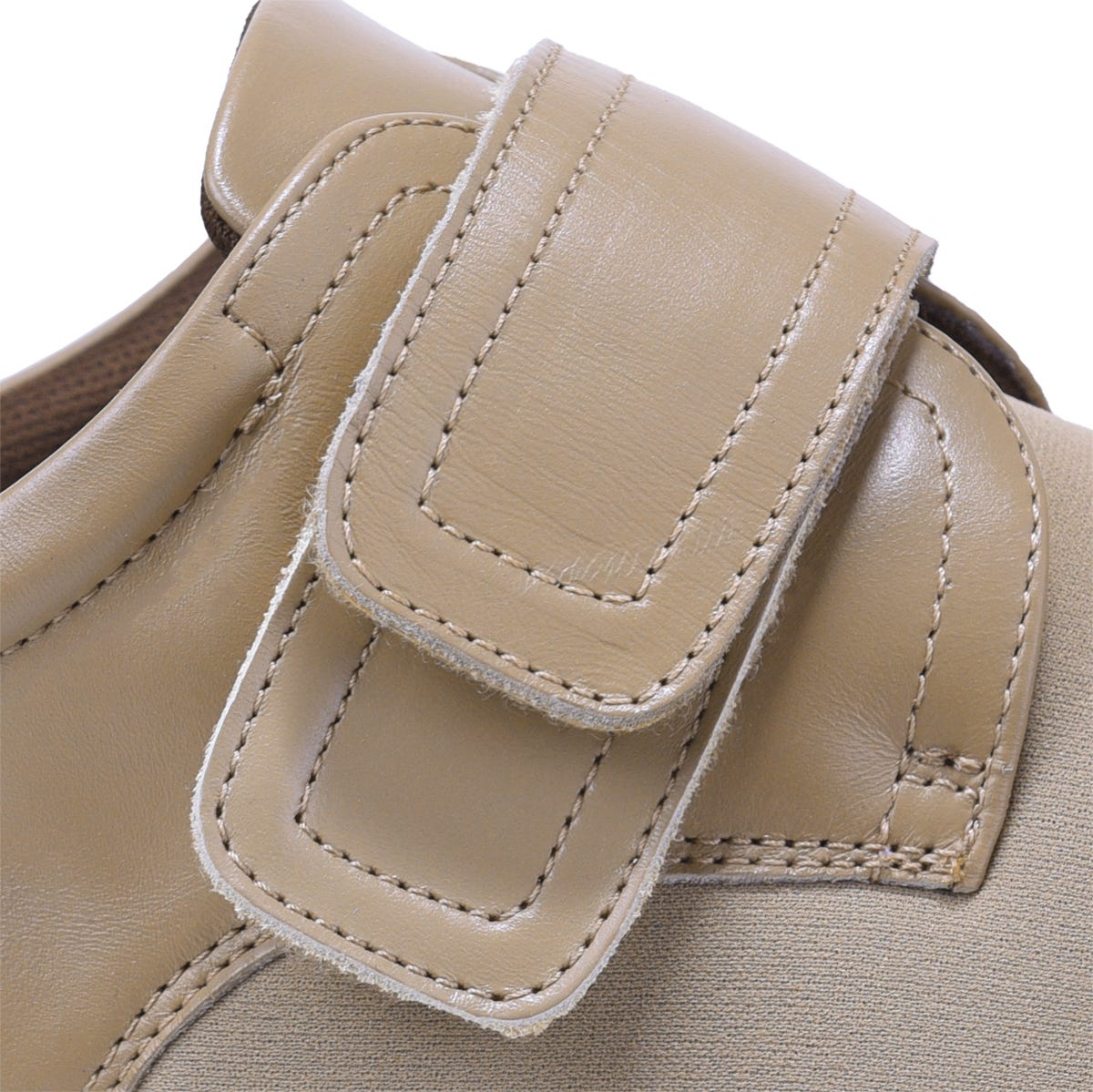 Beige leather strap extension with a rectangular buckle, featuring contrasting stitching, designed to enhance the fit of footwear.