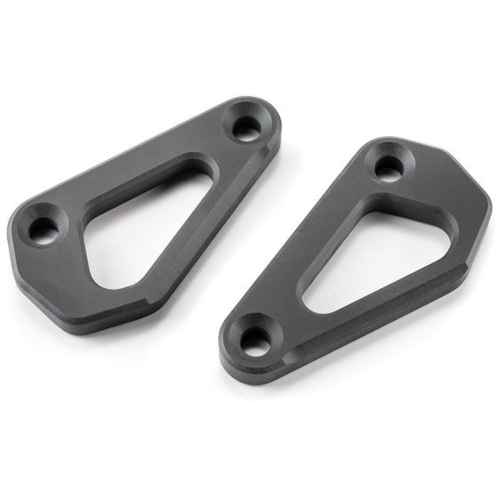 Two triangular, dark gray aluminum footrest eliminators for the Kriega Aprilia Tuareg 660, featuring smooth edges and multiple mounting holes for installation.