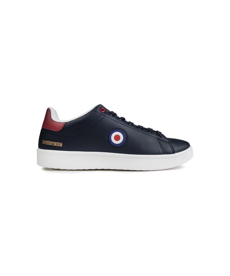 Navy trainers featuring a smooth leather upper, contrasting red heel, white sole, and a circular emblem with blue, white, and red accents on the side.