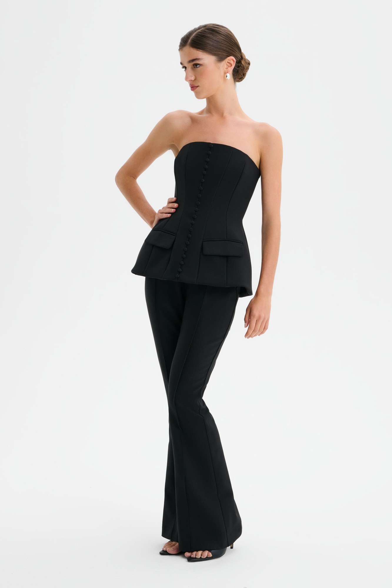 Structured strapless jumpsuit in black featuring a fitted bodice with buttons, side pockets, and flared trousers, designed by Lavish Alice in size XXL UK18.