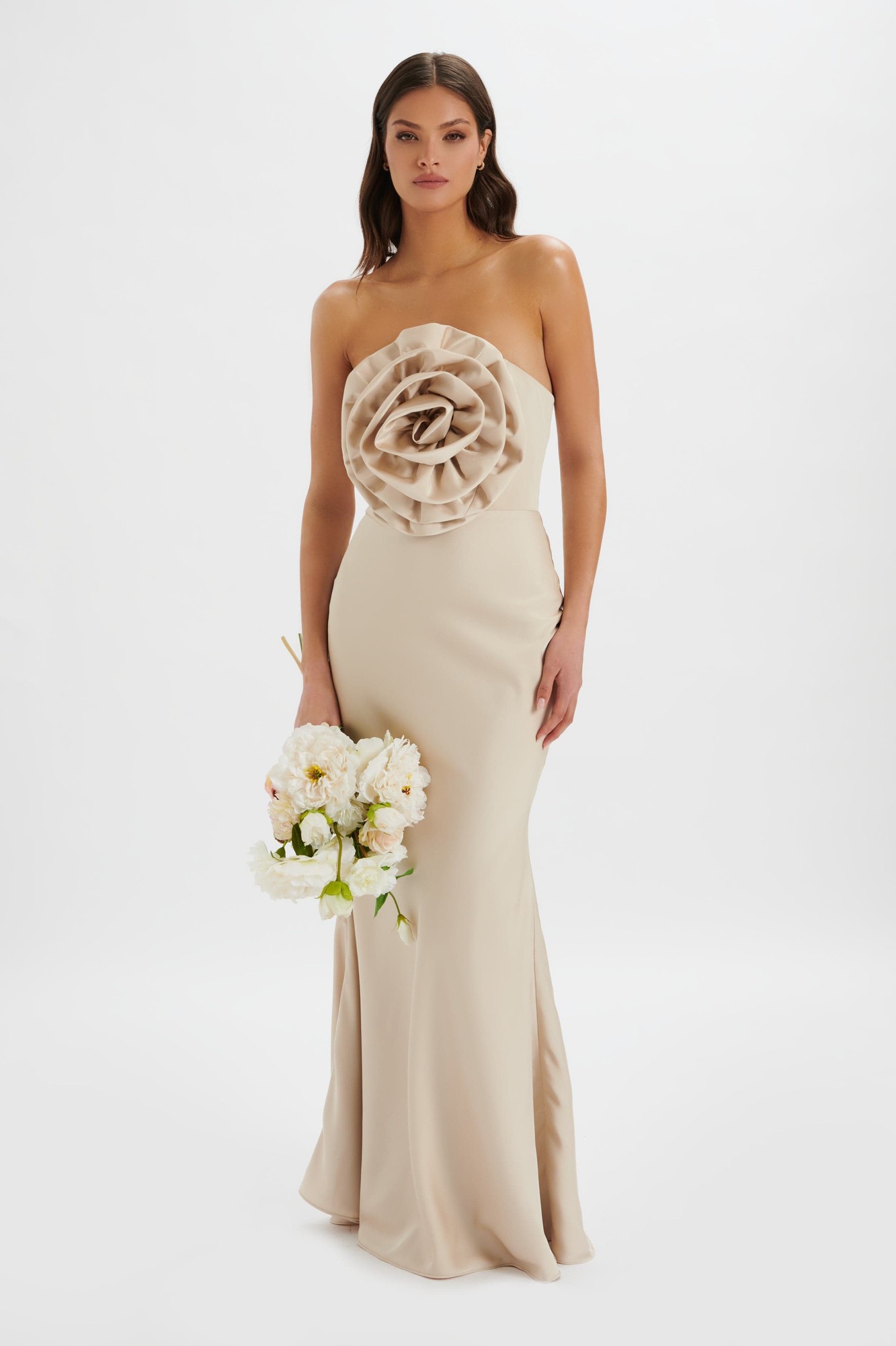 Champagne bandeau maxi dress featuring a 3D flower detail at the bust, sleek fitted silhouette, and soft fabric, perfect for formal occasions.