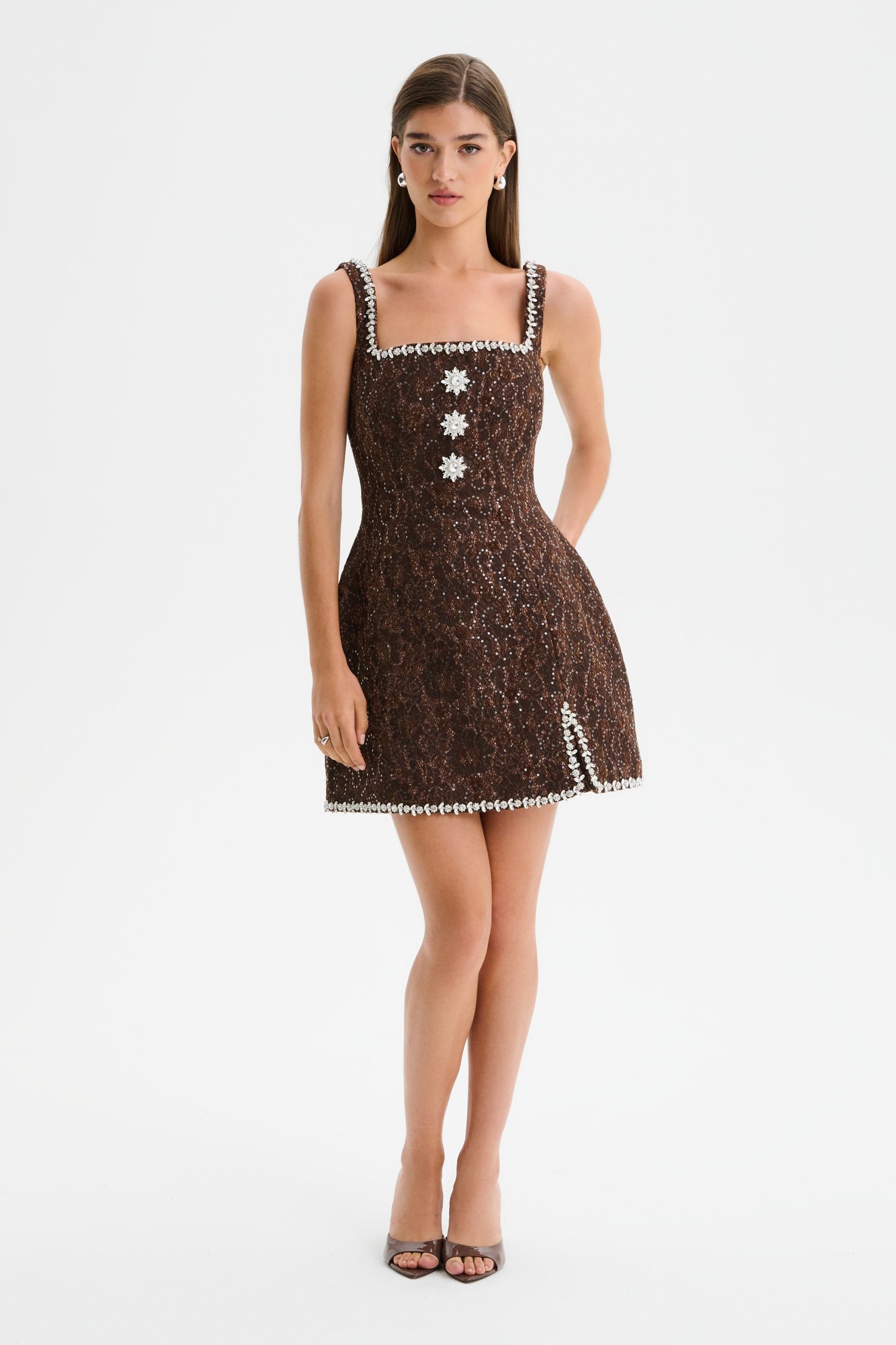 Chocolate brown lace boucle mini dress with a tulip silhouette, embellished with floral details and pearl-like trim, featuring a square neckline and fitted bodice.