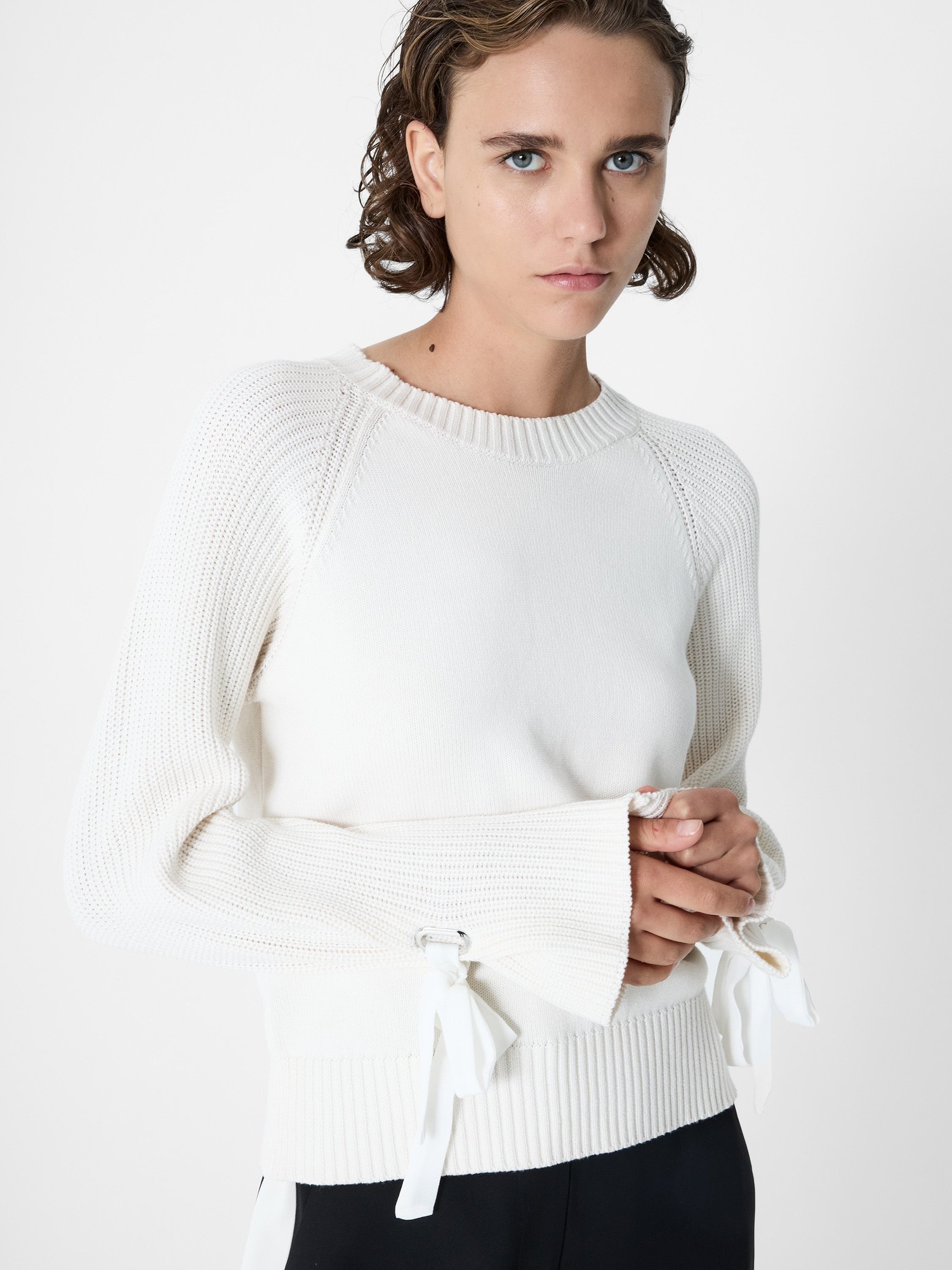 Porcelain cream jumper with a textured knit, featuring long sleeves with slv trim and ribbon ties at the cuffs, designed by French Connection.