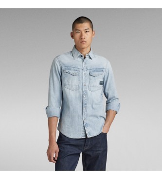 Light blue long sleeve G-Star Dakota shirt in denim fabric, featuring two chest pockets and button-up front, paired with dark jeans.