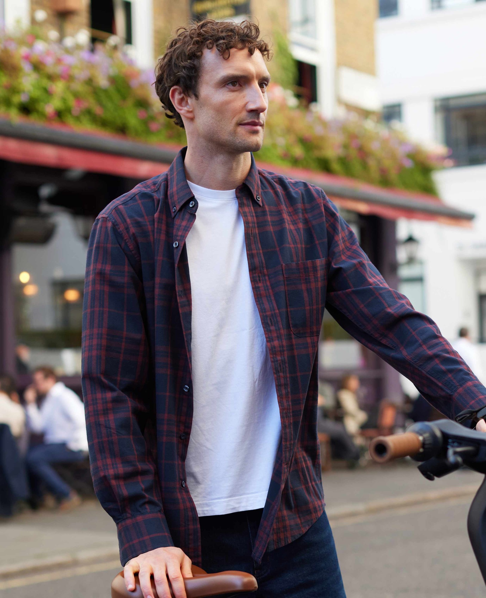 Burgundy and navy brushed cotton check button-down shirt with a classic fit, worn over a white t-shirt, featuring a casual style and visible buttons.