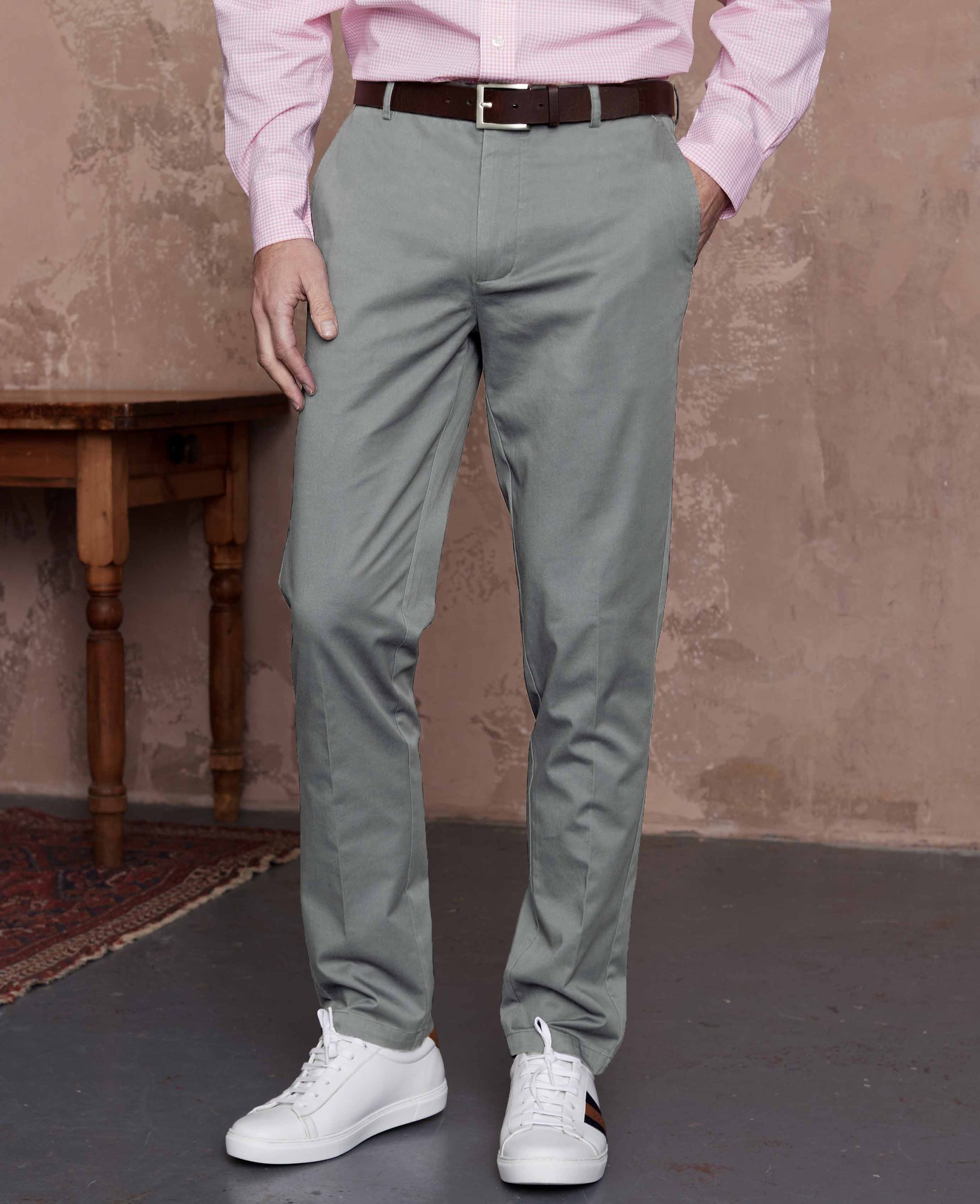 Men's grey stretch cotton chinos with a classic fit and flat front, featuring a size of 36" x 34", paired with a pink shirt and white sneakers.