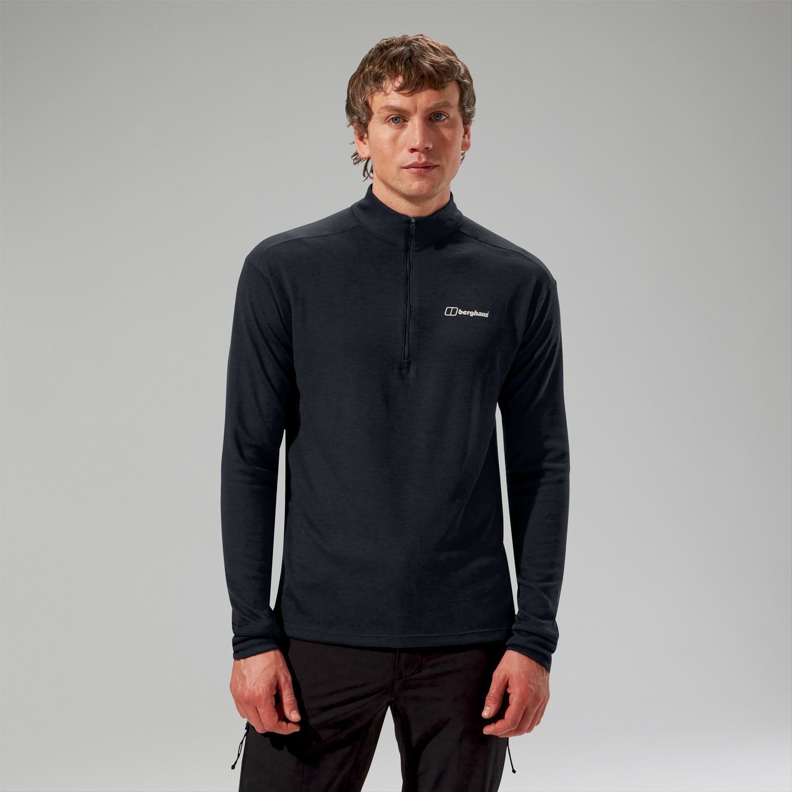 Men's black Ivyhill half zip top by Berghaus, featuring a stand-up collar, long sleeves, and a logo on the chest, made from a lightweight, breathable material.