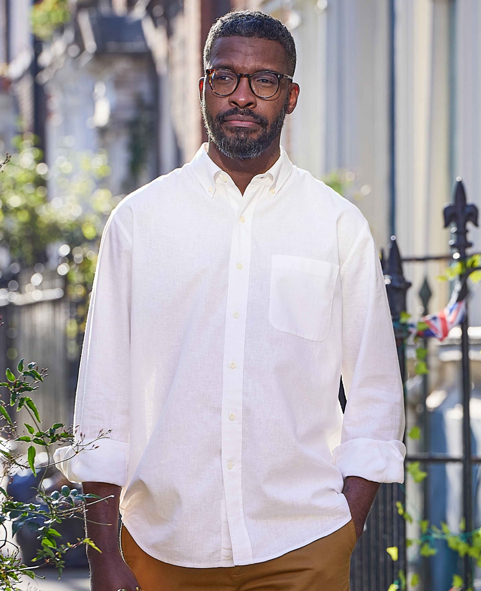 Men's white linen-blend casual shirt with a classic fit, button-down collar, single chest pocket, and long sleeves, worn by a man outdoors.
