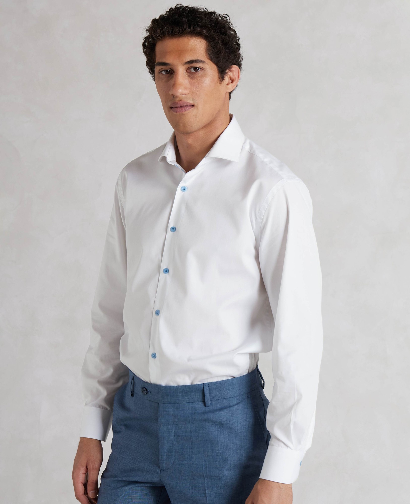 Men's white slim fit smart-casual shirt featuring blue buttons, single cuffs, and made from a smooth material, designed in size small extra long (35").