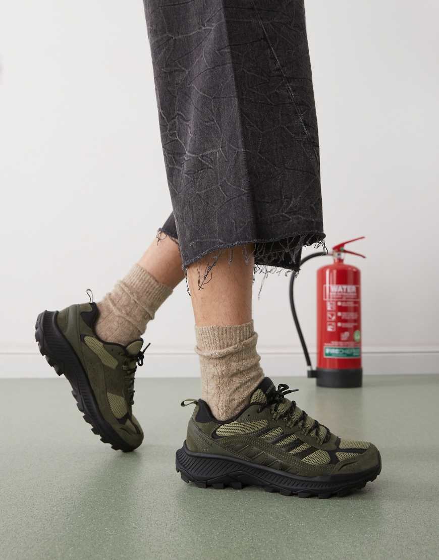 Olive green Merrell Speed Strike 2 Trek men's climbing shoes feature a mesh upper, sturdy rubber sole, and a sleek design, worn with dark pants and beige socks.