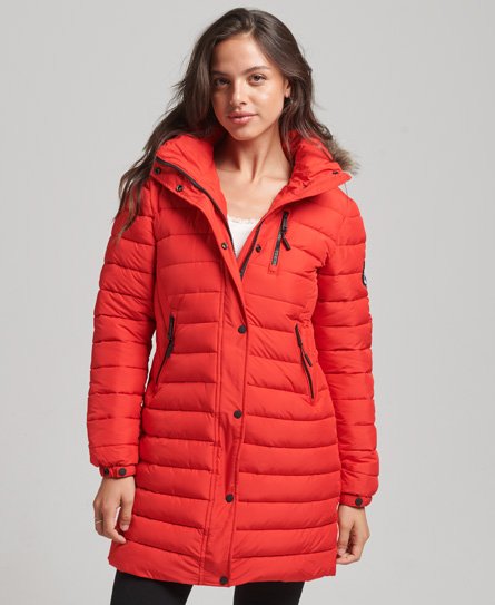 Mid-length red hooded puffer jacket with faux fur trim, featuring a zip and button closure, side pockets, and a quilted design, designed for women by Superdry.