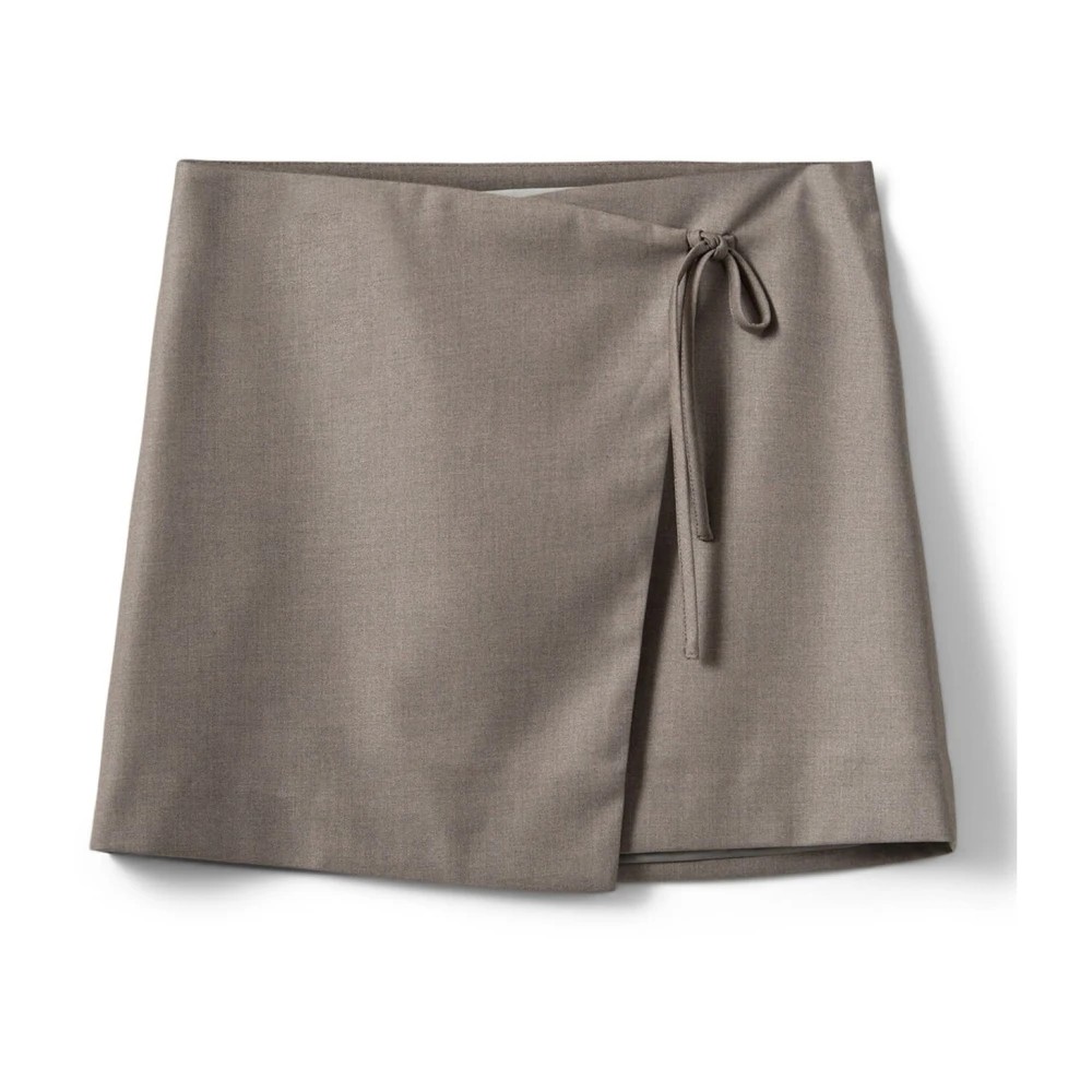 Light brown mini skirt by Sofie Schnoor, featuring a wrap design with a tie closure, made from smooth fabric with a subtle sheen.
