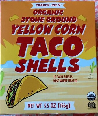 Bright orange box featuring "Organic Stone Ground Yellow Corn Taco Shells" with a taco illustration, listing 12 shells, 5.5 oz, and USDA organic label.