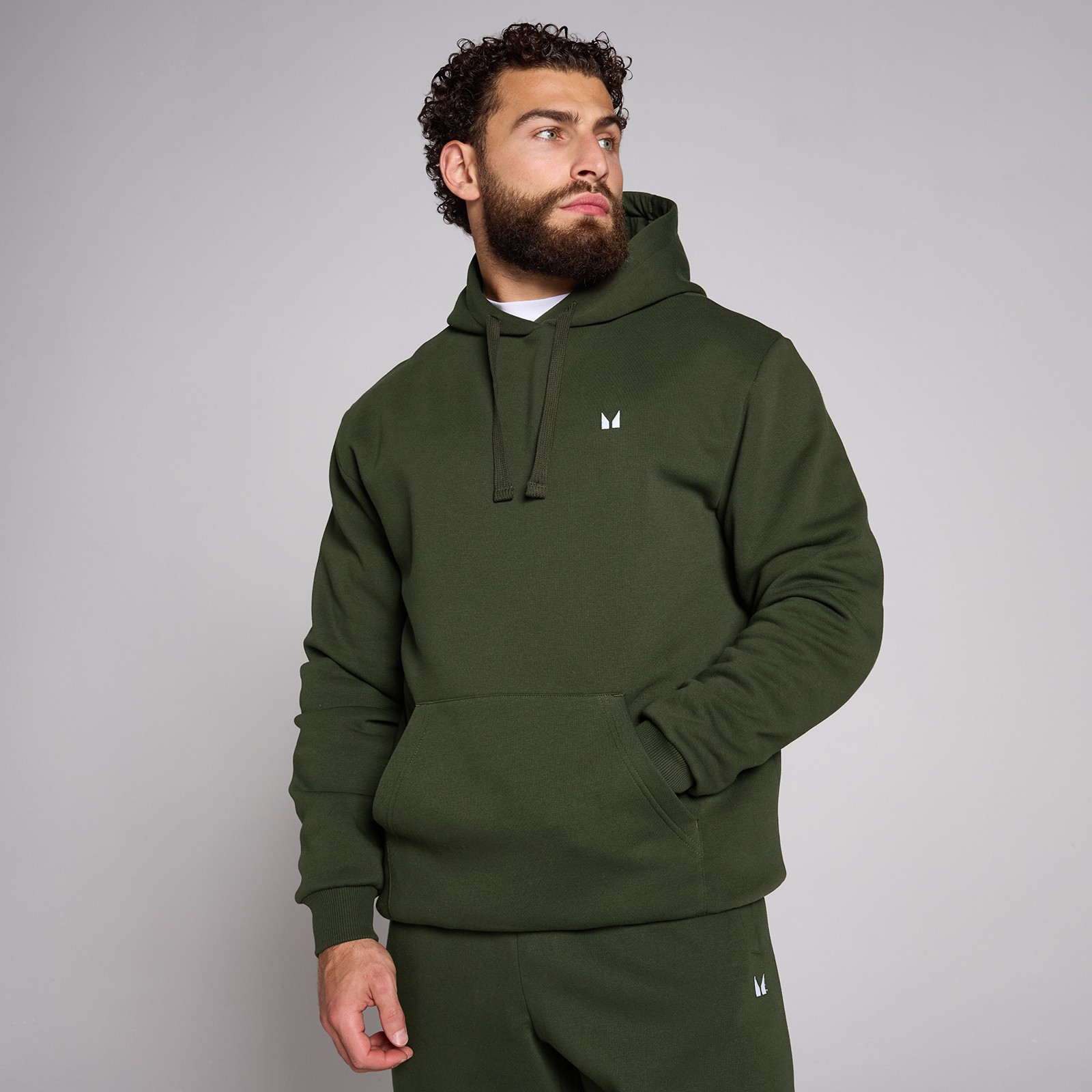 Waldgrün hoodie for men by MyProtein, featuring a drawstring hood, front pocket, and a subtle logo on the chest, made from soft, comfortable material.