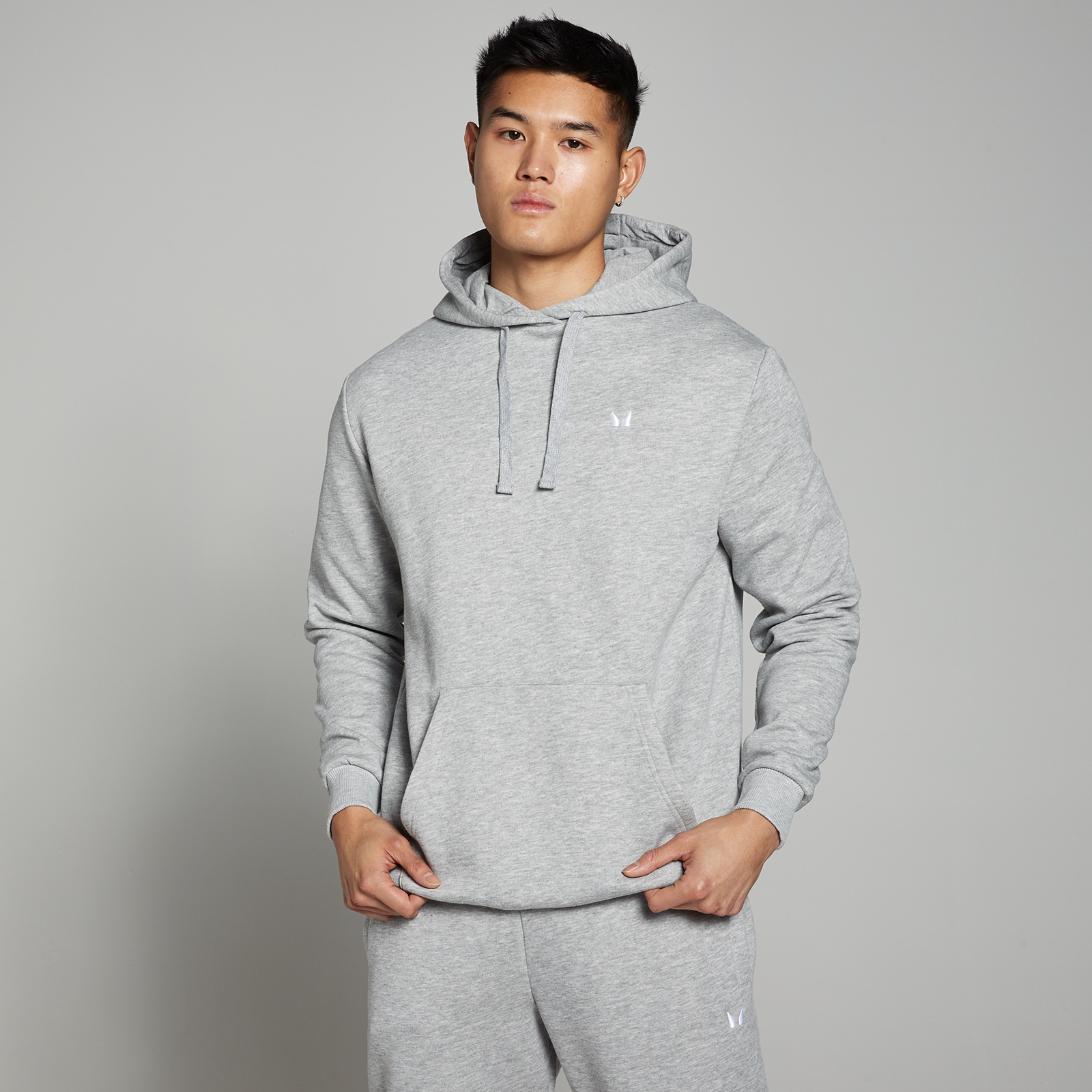 Gray marled men's hoodie from the Rest Day series by MP, featuring a drawstring hood, front pocket, and a relaxed fit, styled with a minimal logo on the chest.
