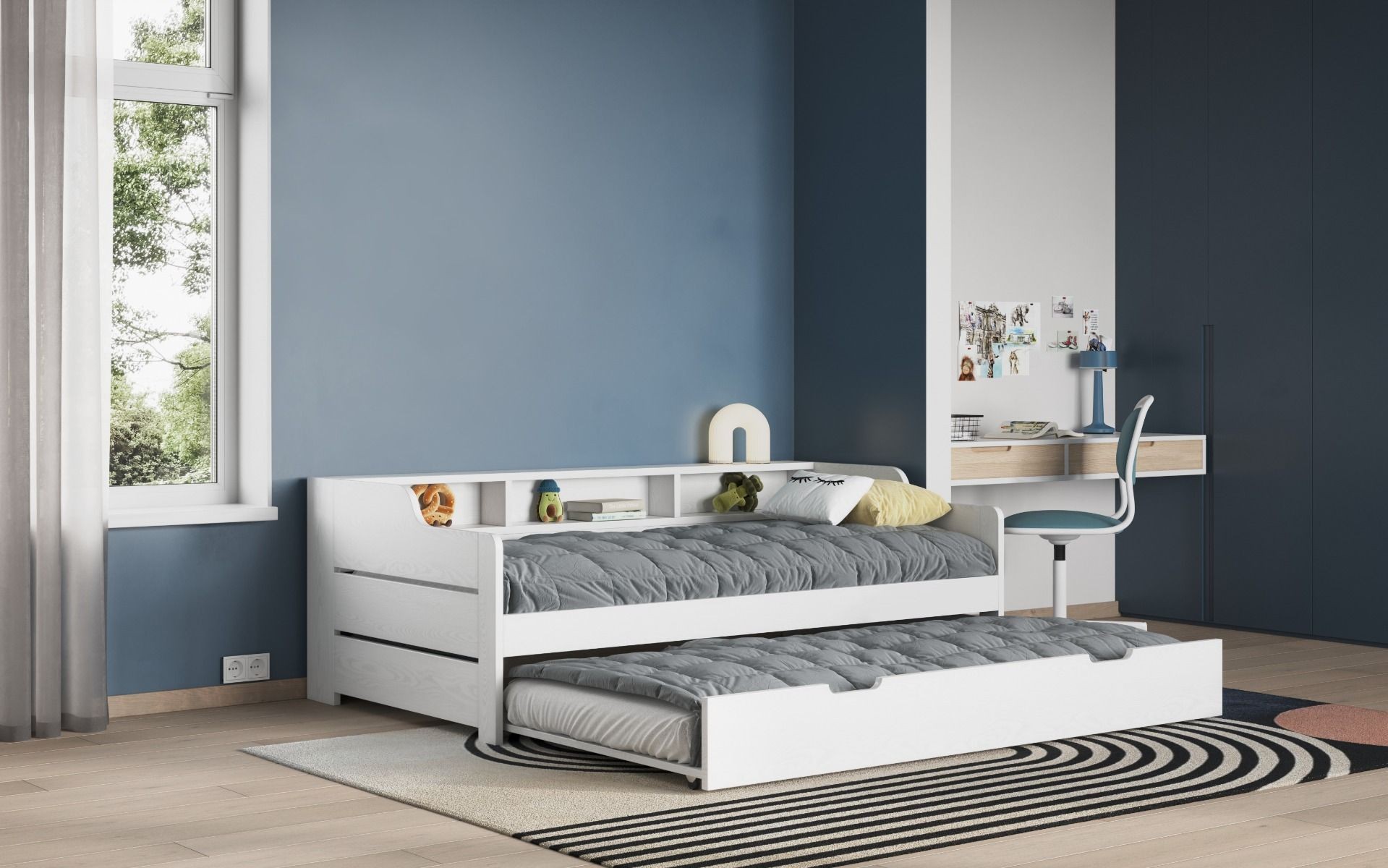 White wooden Enzo Day Bed with a pull-out trundle, featuring a sleek design, grey mattresses, and built-in storage shelves, set against a blue wall and light wooden floor.