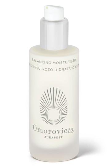 Clear glass bottle with a frosted finish, featuring a white pump top, labeled "Balancing Moisturiser" and "Omorovicza Budapest" in elegant black font.