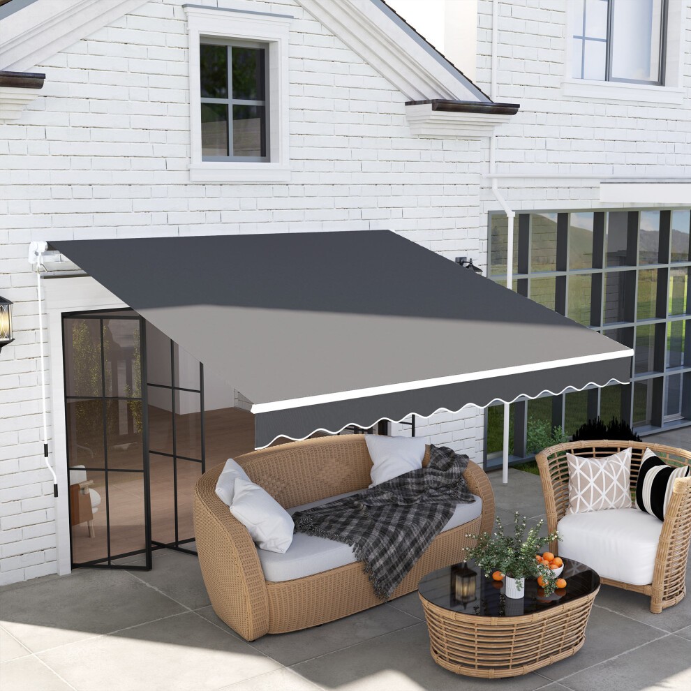 Dark grey canopy sun shade shelter with a crank handle, featuring a scalloped edge, set above a patio area with wicker furniture and a small table.