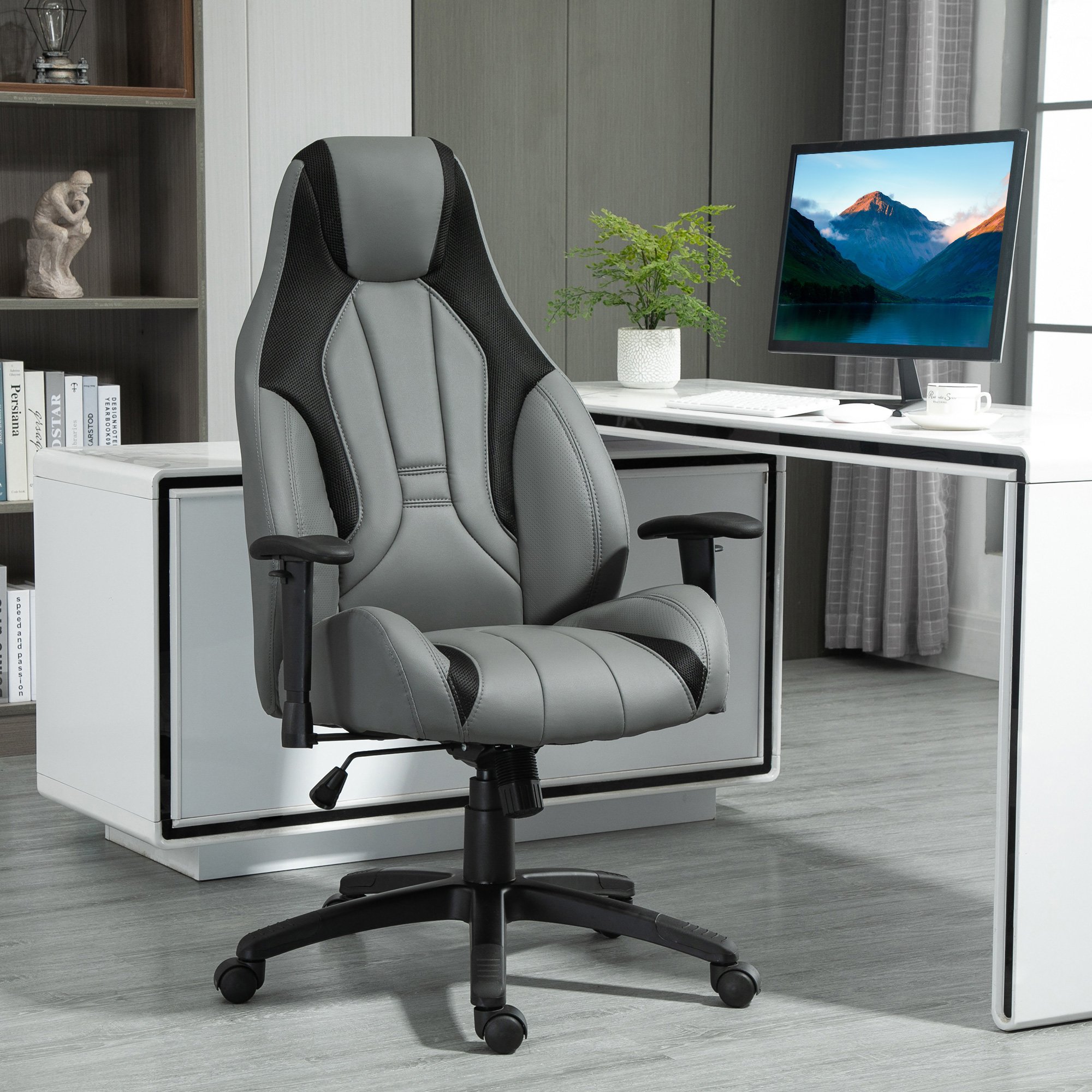 Charcoal grey high back executive office chair featuring mesh and faux leather, adjustable height, armrests, and swivel wheels, set against a modern office backdrop.