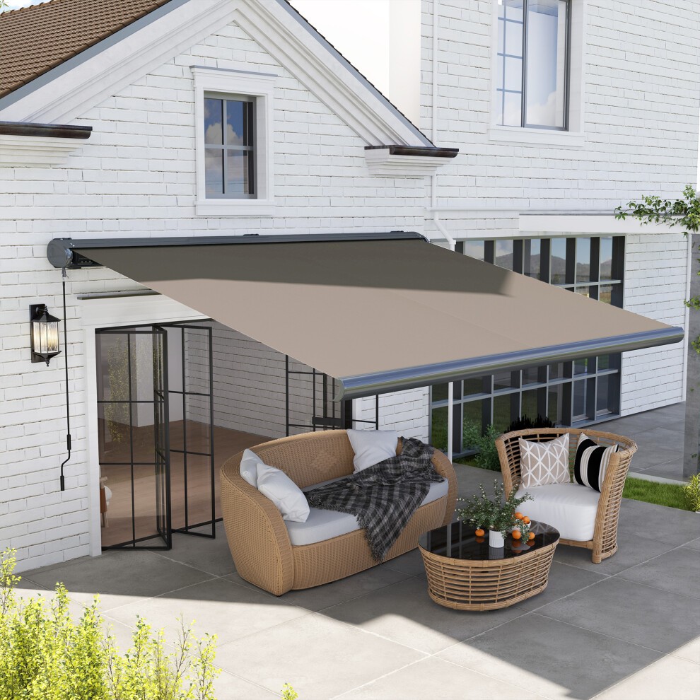 Light grey full cassette electric awning with an aluminium frame, extending over a patio area featuring wicker furniture and a cozy blanket.