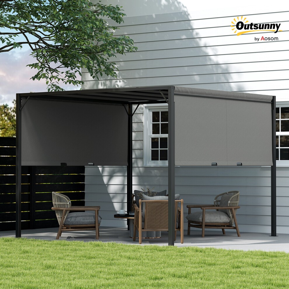 Grey metal gazebo with a slanted roof, featuring side shades, set in a patio area with wooden chairs and a table, surrounded by greenery and a white wall.