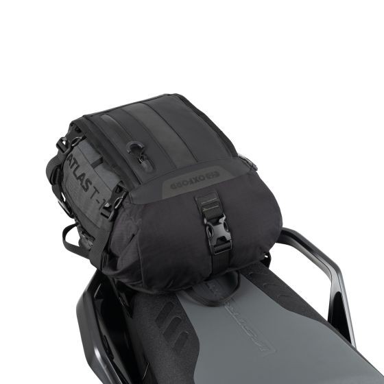 Black waterproof Oxford Atlas T-10 luggage bag, featuring a sleek design, adjustable straps, and a compact size of 10 liters, secured on a motorcycle seat.