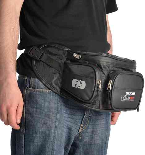 Black Oxford XW3R waist bag worn at the waist, featuring multiple zippered compartments, a sleek design, and a logo, suitable for men, with a capacity of 0-5 liters.