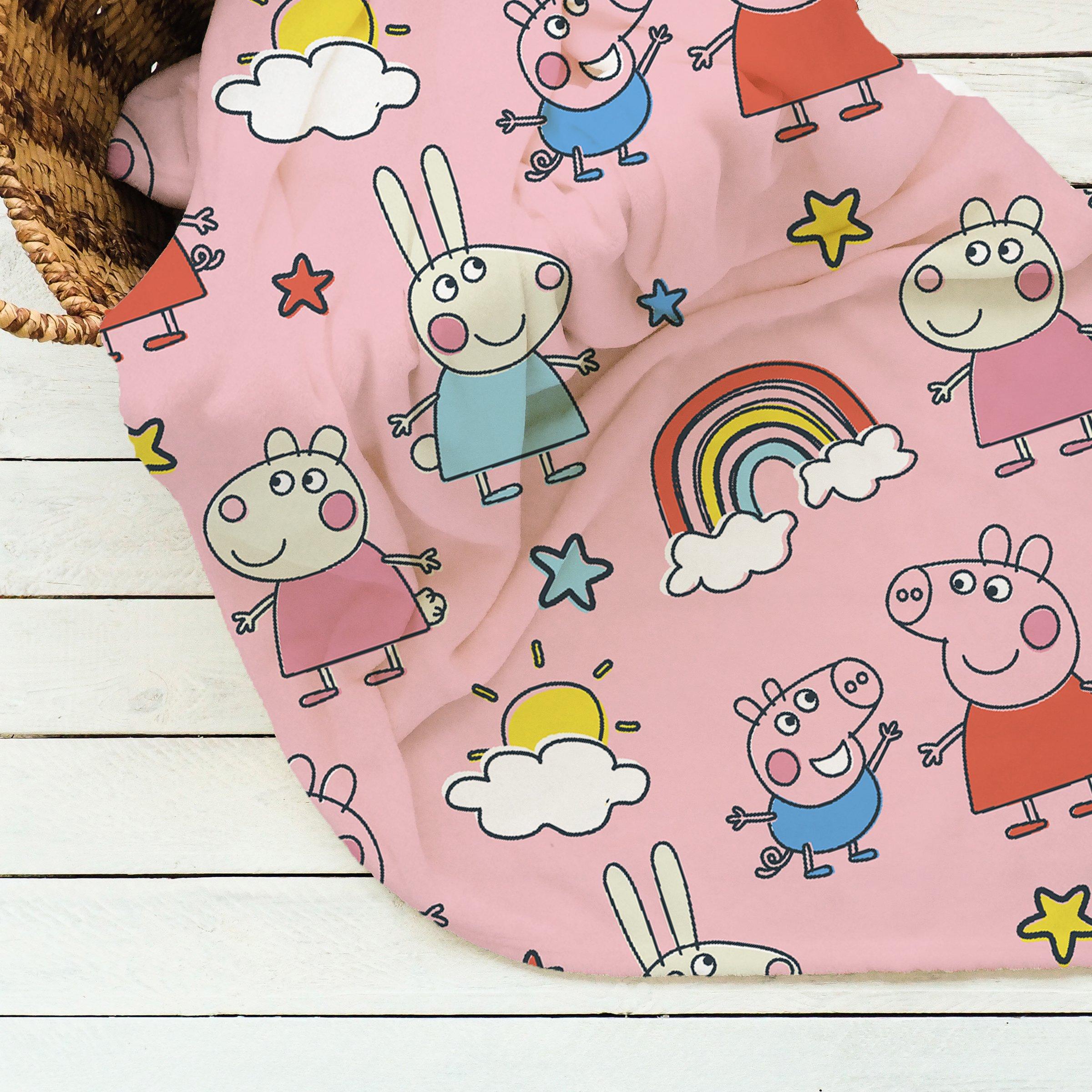 Multicoloured Peppa Pig kids throw featuring cartoon characters on a pink background, with stars, clouds, and a rainbow, measuring 150x100cm, made from soft material.